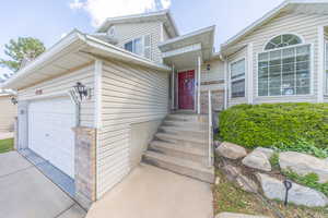 View of front of house with an attached garage and driveway