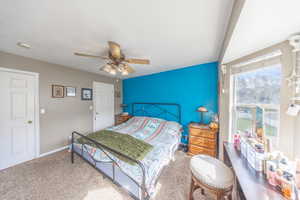 Carpeted bedroom featuring a ceiling fan and baseboards