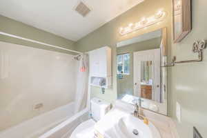 Full bathroom with vanity and shower / bath combo