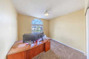Office space with carpet flooring and baseboards