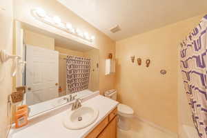 Bathroom with vanity and light floors
