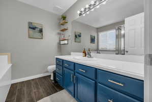 Full bathroom featuring vanity, a garden tub, wood tiled floors, and a shower stall