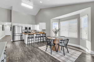 Dining room with lofted ceiling and dark wood finished floors