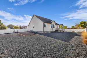 Rear view of house featuring a fenced backyard