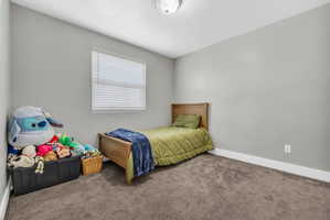 Bedroom with carpet and baseboards