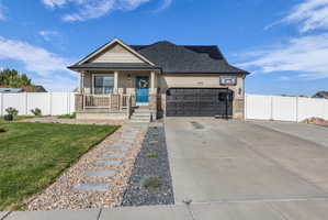 Craftsman house with an attached garage, a porch, driveway, roof with shingles, and stucco siding