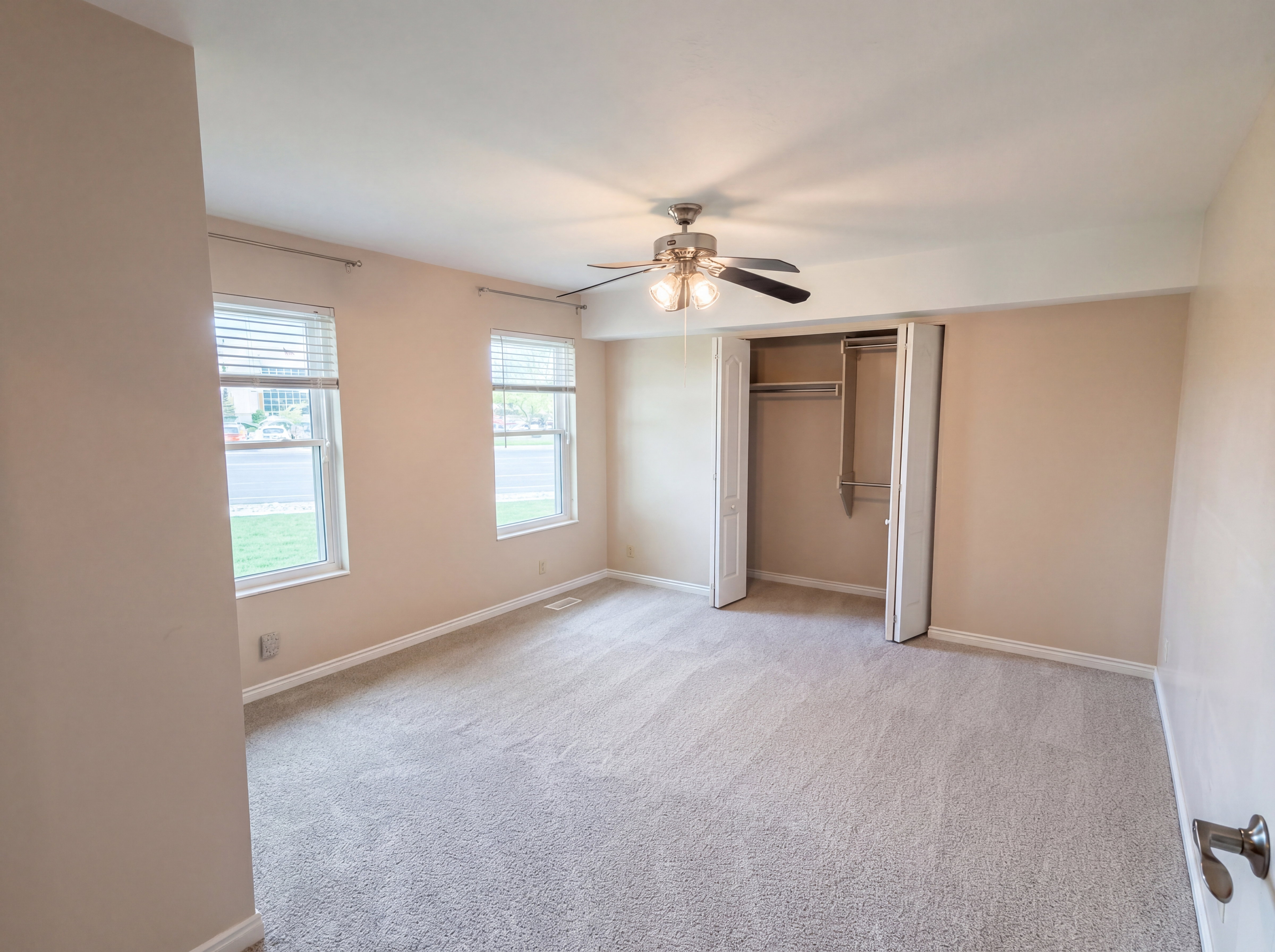 Unfurnished bedroom with a closet, light carpet, and a ceiling fan
