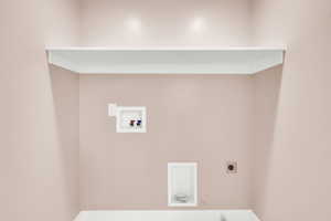 Laundry area in primary bathroom with washer hookup and hookup for an electric dryer