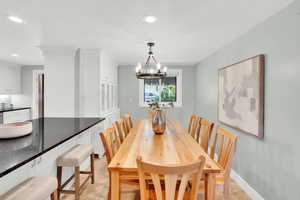 Dining space featuring a chandelier and light tile patterned flooring
