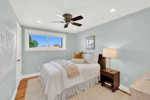 Bedroom featuring light wood-type flooring, a ceiling fan, and recessed lighting