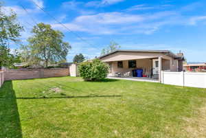 Rear view of property with a fenced backyard, stucco siding, a patio, and a storage shed