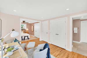Bedroom featuring light wood-style floors, ceiling fan, and recessed lighting
