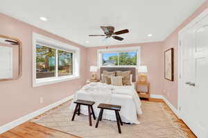 Bedroom featuring light wood-style floors, a ceiling fan, and recessed lighting