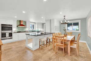 Dining area featuring a chandelier and baseboards
