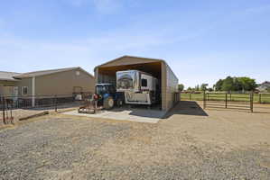 View of parking with a carport
