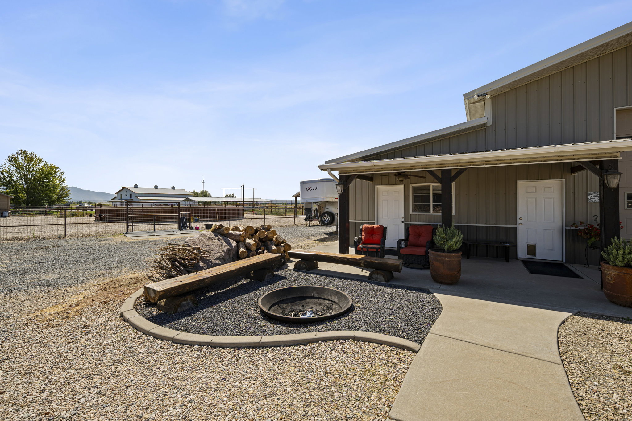 View of yard featuring an outdoor fire pit and covered porch