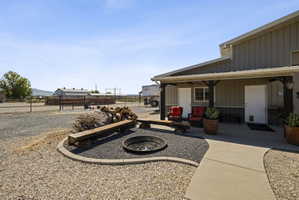 View of yard featuring an outdoor fire pit and covered porch