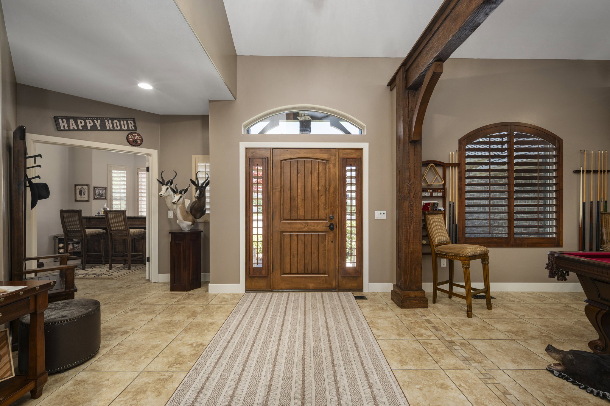 Entrance foyer with light tile patterned floors, plenty of natural light, and billiards table
