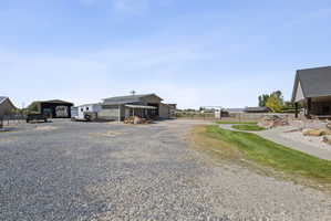View of dirt / gravel road featuring a gated entry