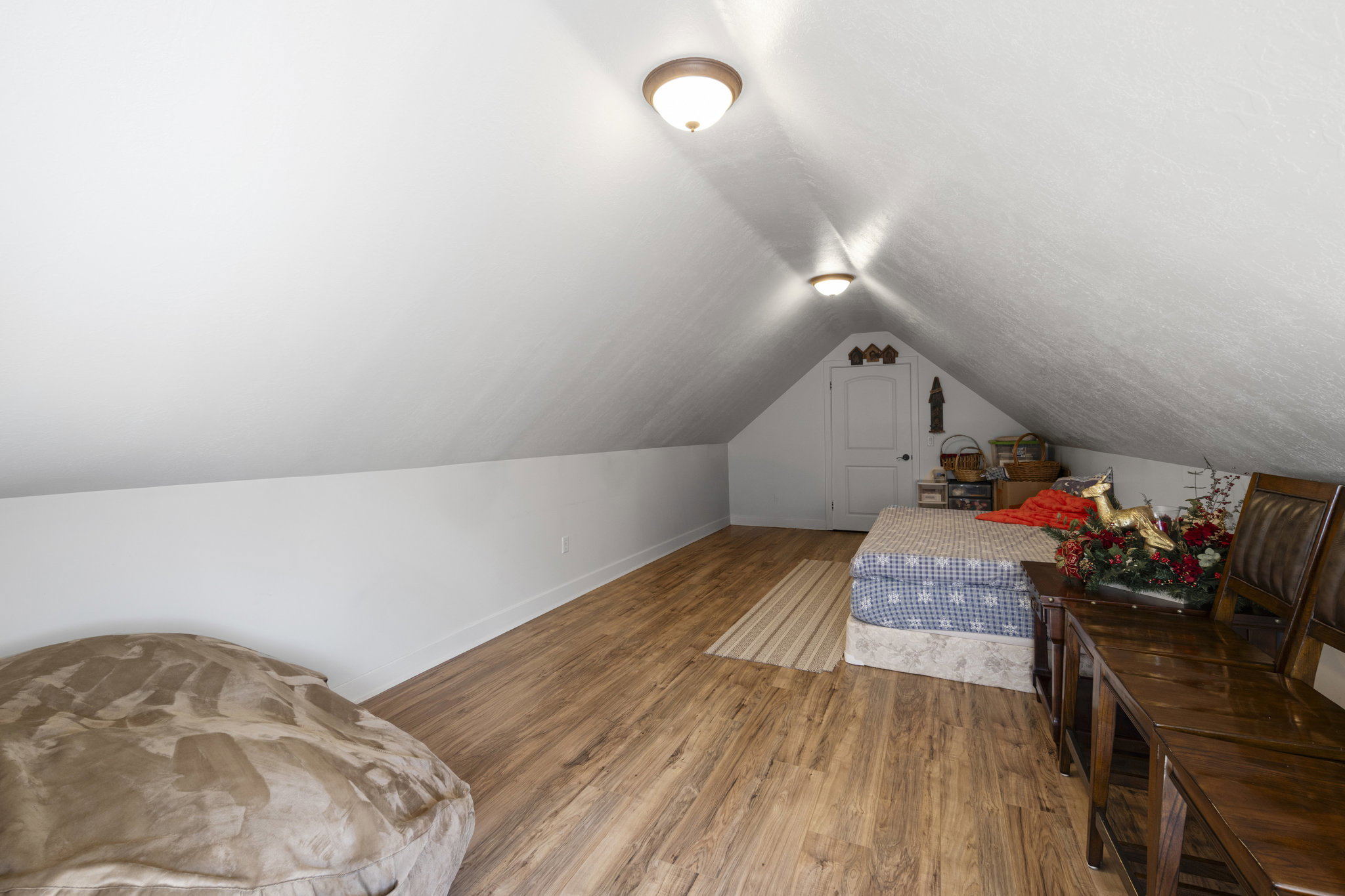 Bedroom featuring wood finished floors and baseboards