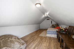 Bedroom featuring wood finished floors and baseboards