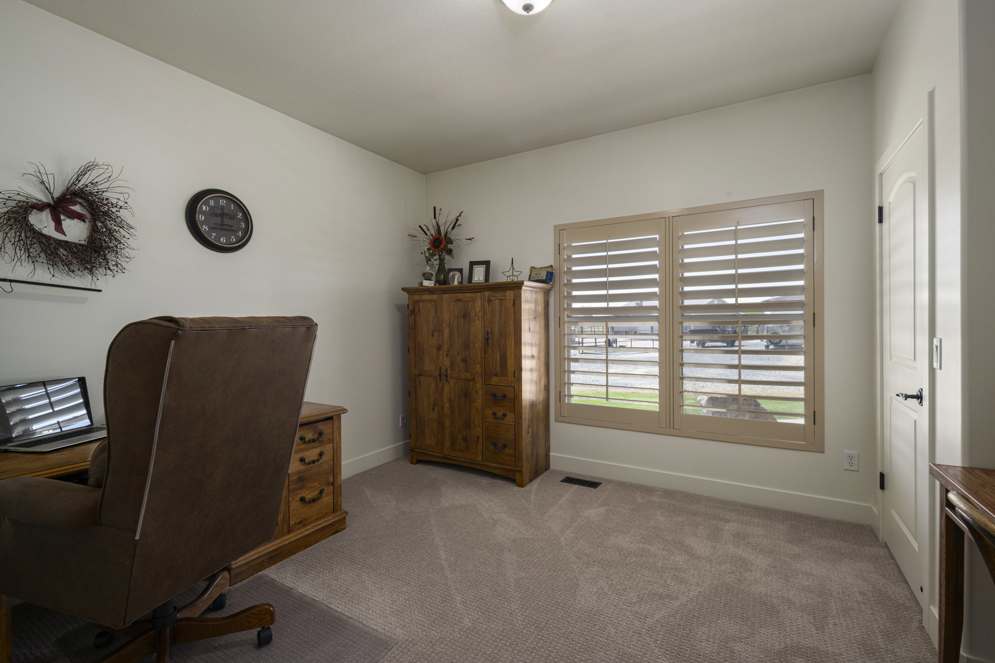 Home office with carpet floors and baseboards