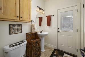 Bathroom featuring toilet and light tile patterned floors