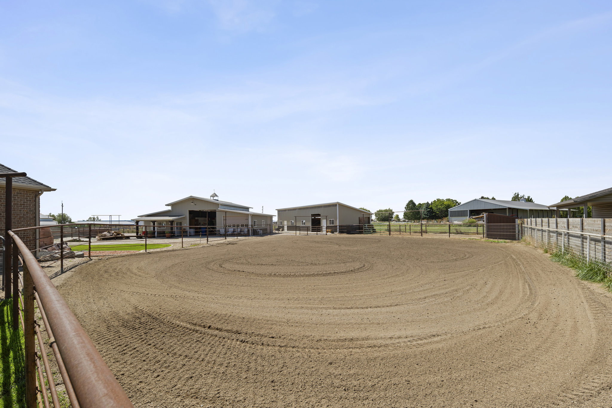 View of yard featuring an enclosed horse arena, an outbuilding, and an exterior structure