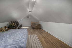 Bedroom featuring wood finished floors and a textured ceiling