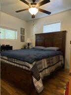 Bedroom featuring a ceiling fan and wood finished floors