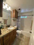 Full bath featuring shower / bathtub combination with curtain and vanity