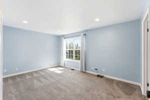 Primary bedroom in Midway condo for sale with large window, soft color palette, and spacious layout