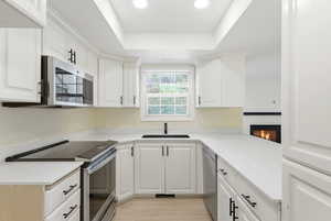 Modern kitchen in Midway condo for sale with quartz countertops, shaker cabinets, stainless steel appliances, and large counter space