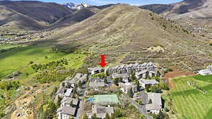 Midway condo for sale aerial with trail system, green space, and mountain views in background. Highlights the connection between the community and nearby trails.