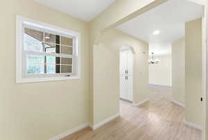 Midway condo entryway with durable flooring, coat storage, and clean transition into open living space