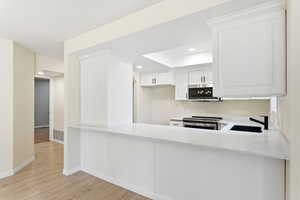 A clean, functional kitchen layout with generous prep space and seating that naturally connects to the main living area