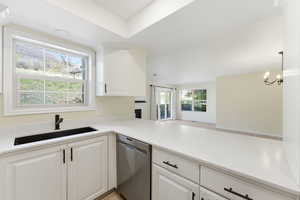 Swiss Oaks condo kitchen with counter seating, modern cabinetry, and direct sightlines to living and dining areas