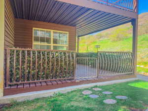 Covered patio featuring a corrugated metal ceiling and wood-finish decking