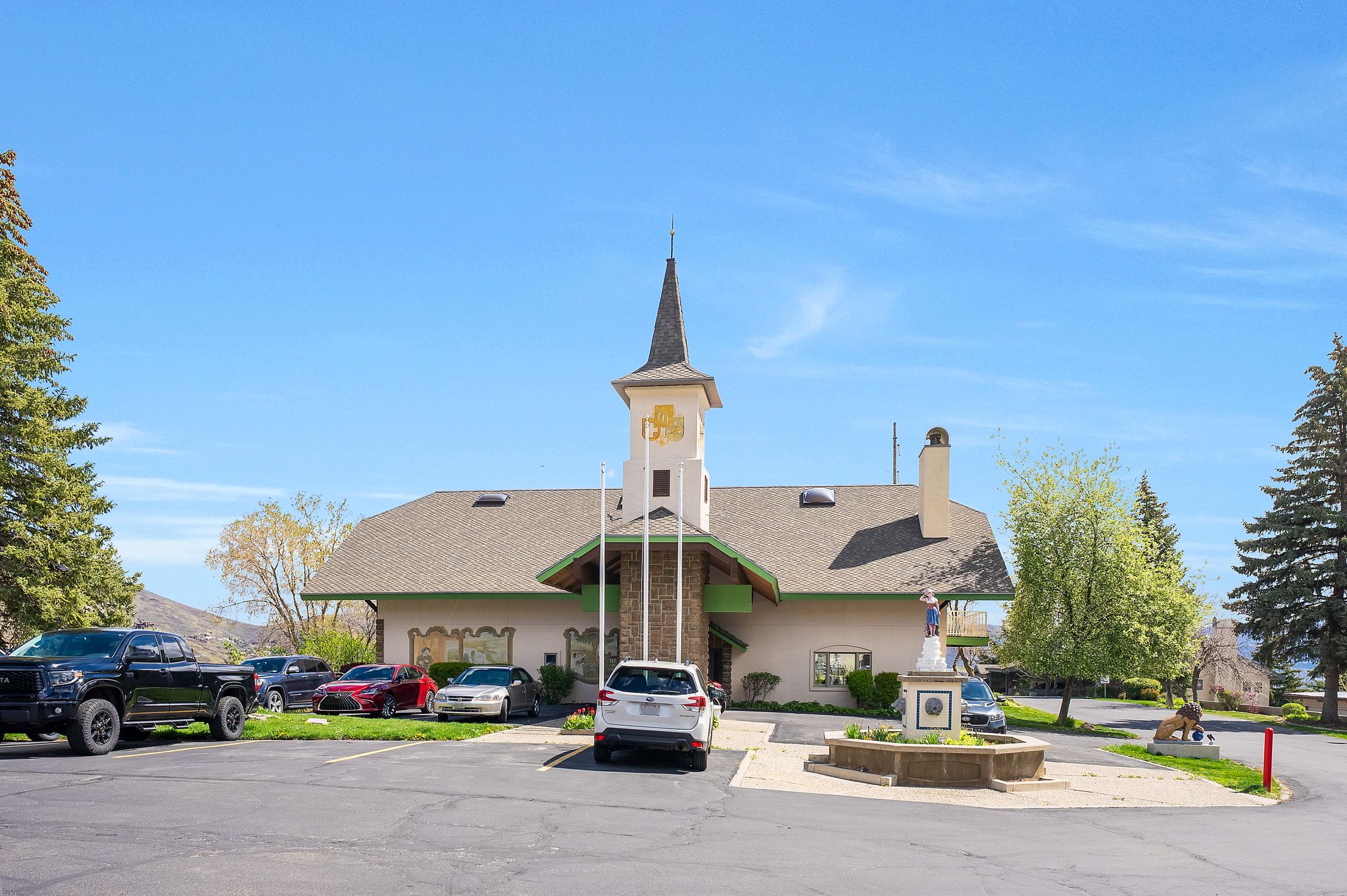 Swiss Oaks clubhouse exterior in Midway with maintained landscaping, building entrance, and community gathering space