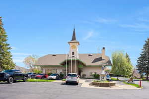 Swiss Oaks clubhouse exterior in Midway with maintained landscaping, building entrance, and community gathering space