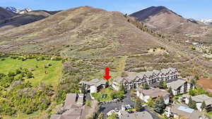 Aerial view of Swiss Oaks Midway condo community with buildings, trails, and surrounding mountain landscape
