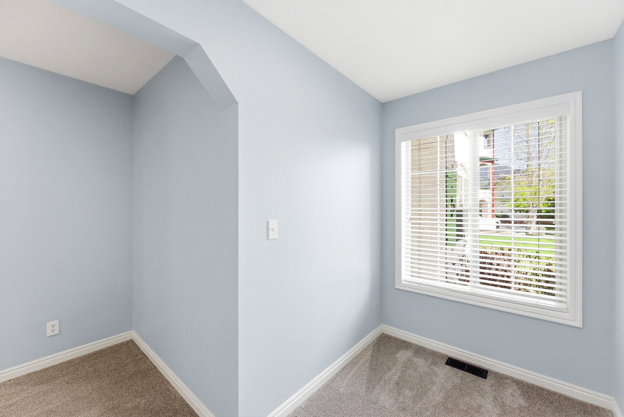 A spacious bedroom with a connected open area that adds versatility for work, hobbies, or extra storage.