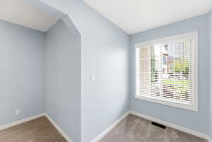 A spacious bedroom with a connected open area that adds versatility for work, hobbies, or extra storage.