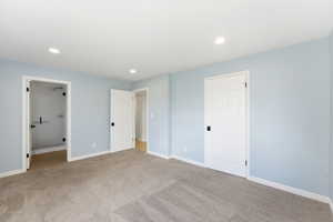 Swiss Oaks primary bedroom with carpet flooring, closet storage, and bright window exposure