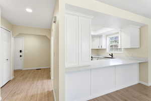Midway condo for sale open entry leading into kitchen and modern lighting