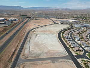 Aerial overview of property's location featuring a mountain backdrop and nearby suburban area