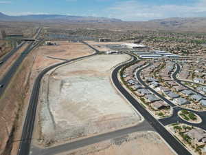 Aerial overview of property's location featuring mountains and nearby suburban area