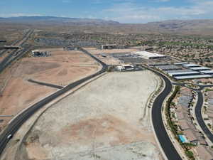 Aerial view of property's location featuring a mountainous background