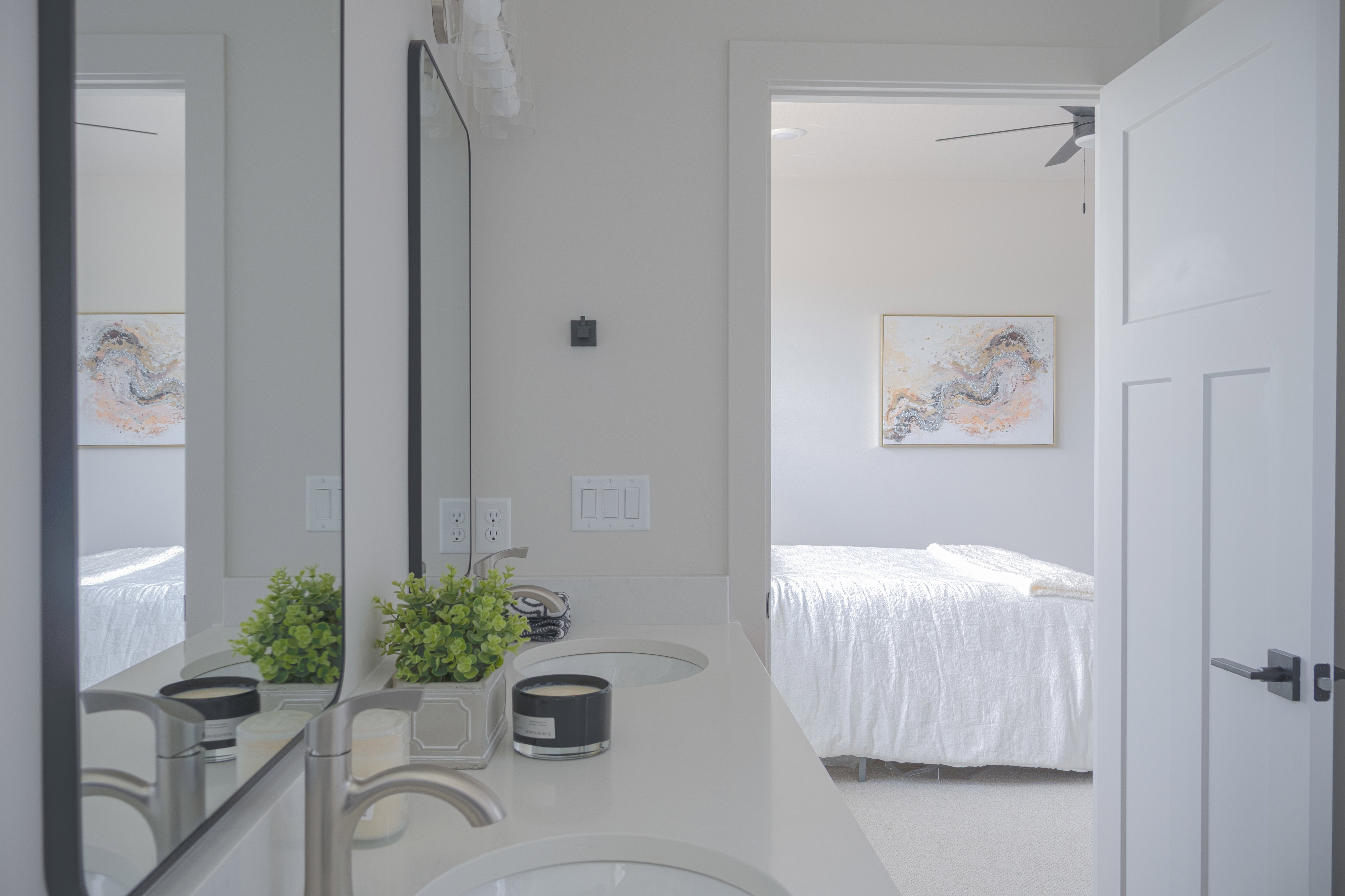 Bathroom featuring double vanity, a ceiling fan, and ensuite bathroom