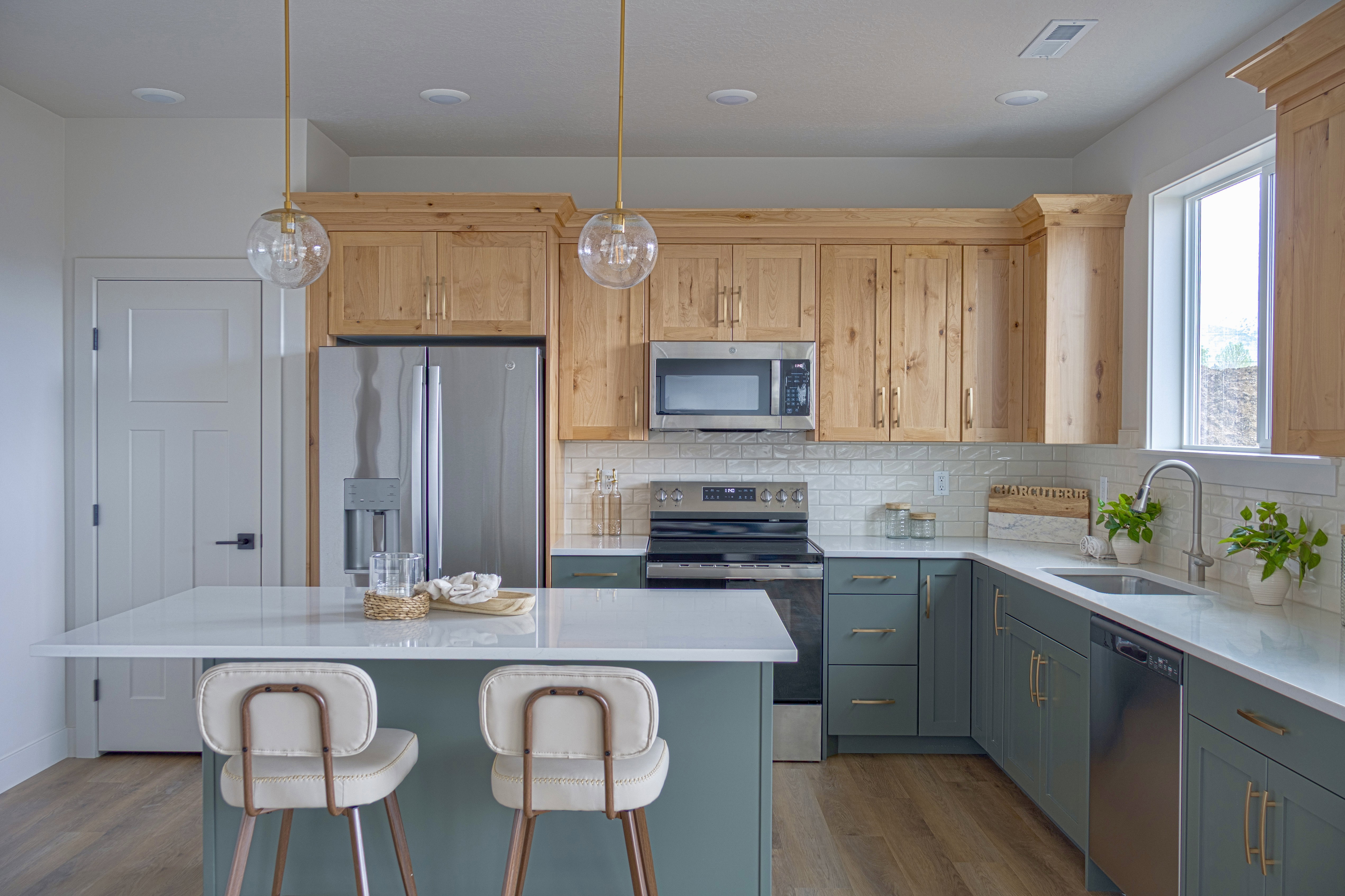 Modern kitchen featuring a central island with a white countertop and seating